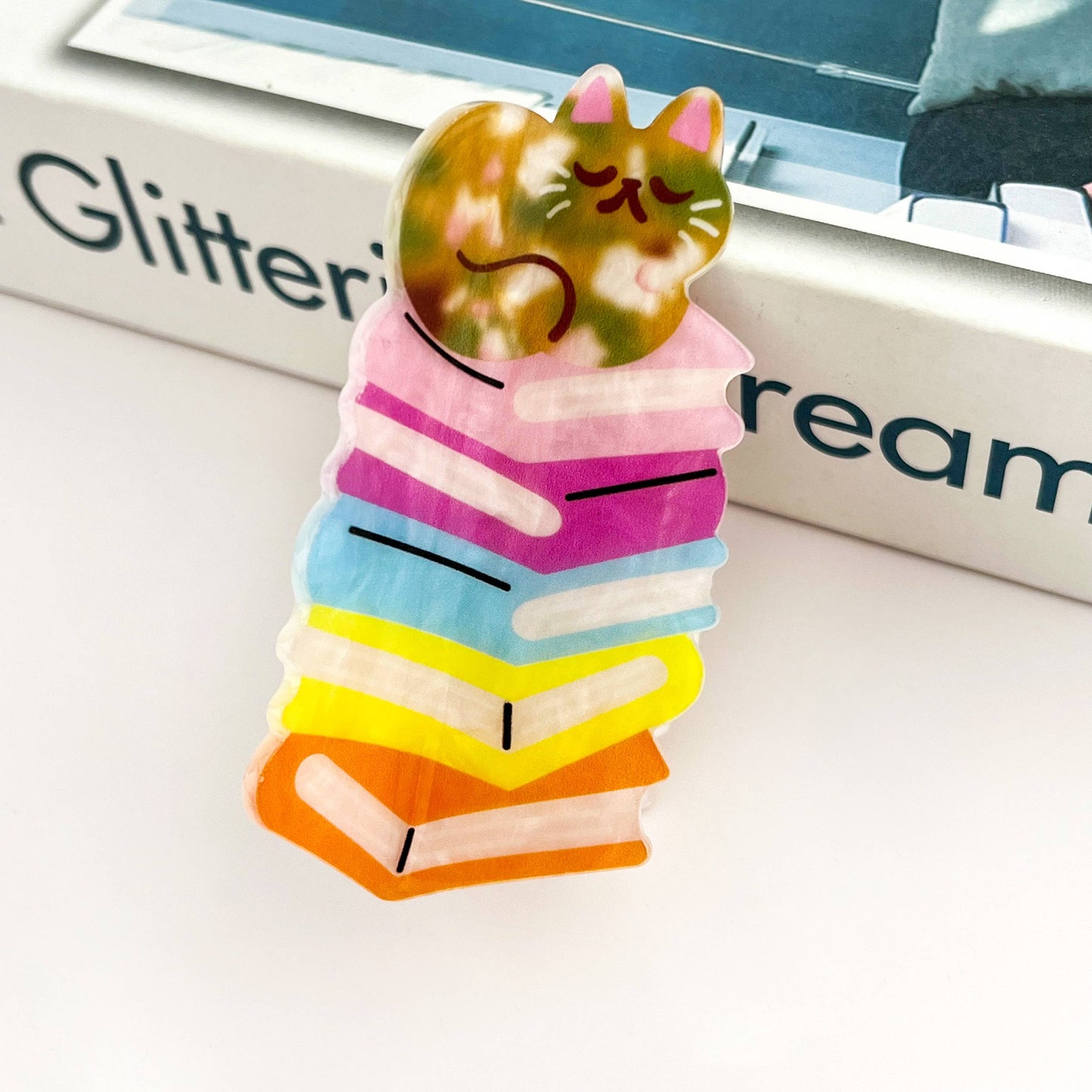 Adorable Sleeping Cat on Rainbow Book Stack Hair Claw: Book-Cat