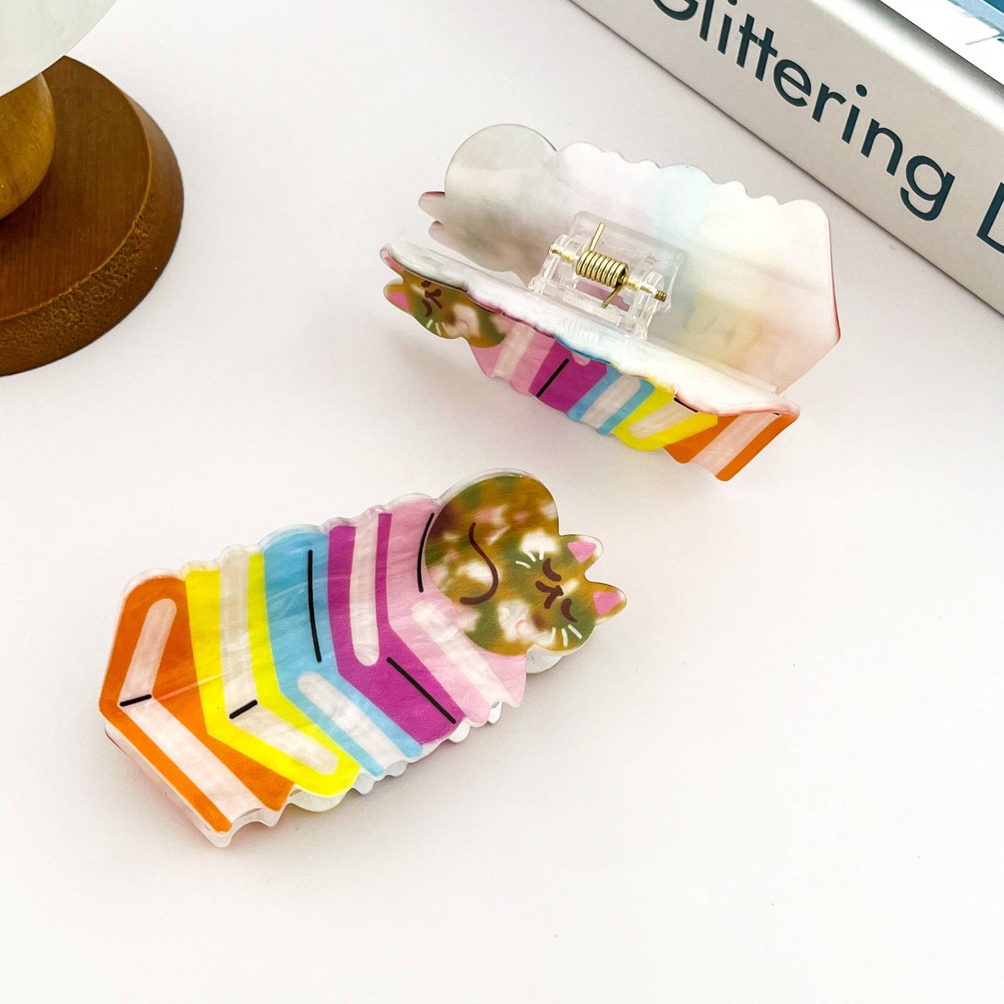 Adorable Sleeping Cat on Rainbow Book Stack Hair Claw: Book-Cat
