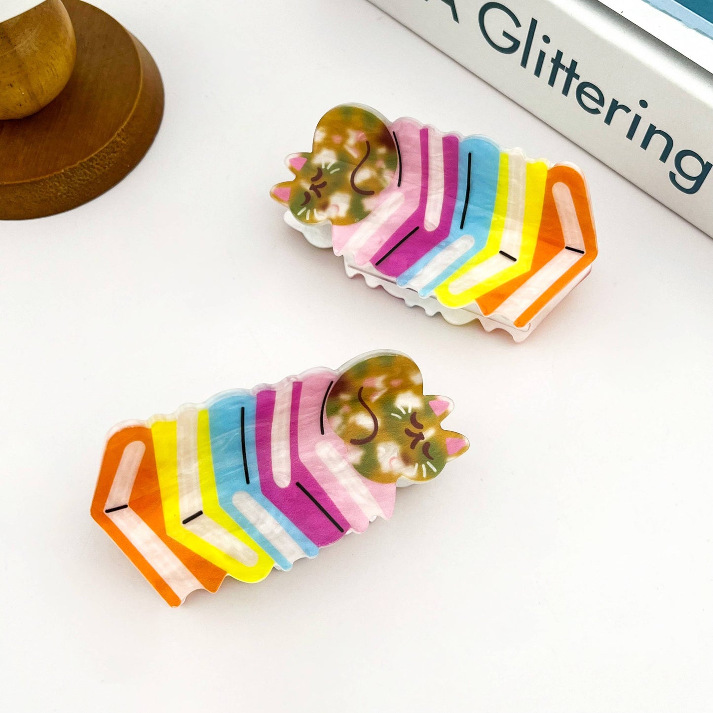 Adorable Sleeping Cat on Rainbow Book Stack Hair Claw: Book-Cat